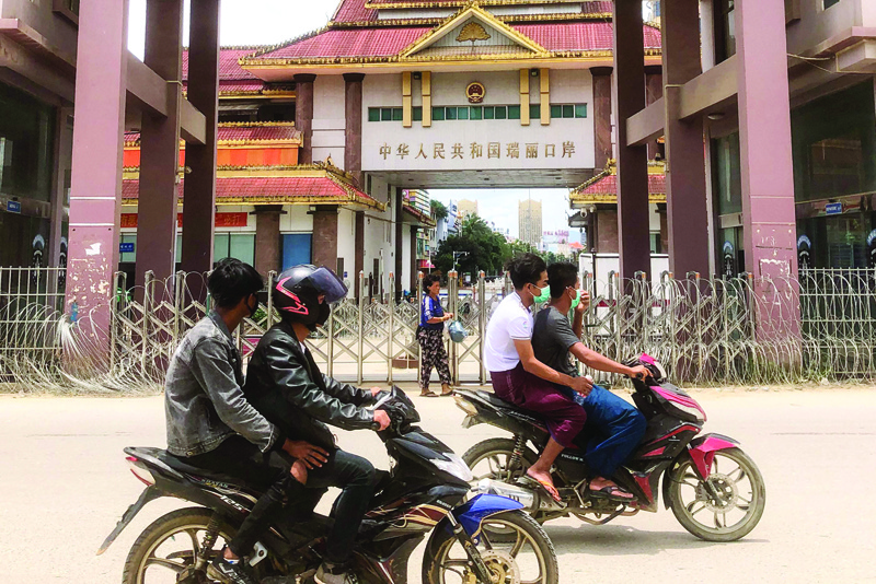 MUSE: In this file photo, motorists pass the China-Myanmar border gate in Muse in Shan state, as the Chinese city of Ruili near the border with Myanmar imposed a lockdown and started mass testing after three COVID-19 coronavirus cases were reported. - AFP n