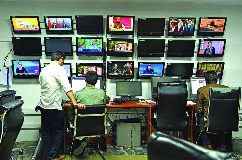 KABUL: Photo shows Afghan reporters of Tolo News work in the newsroom at Tolo TV station in Kabul. - AFP n