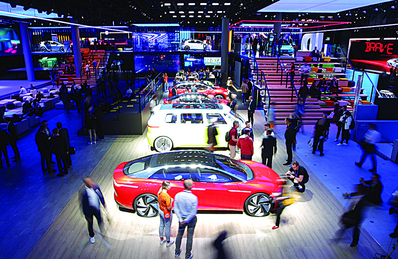 FRANKFURT: Visitors are pictured at the booth of German car maker Volkswagen at the International Auto Show (IAA), in Frankfurt am Main, on September 11, 2019. The German IAA motor show opens tomorrow in Munich.-AFPn