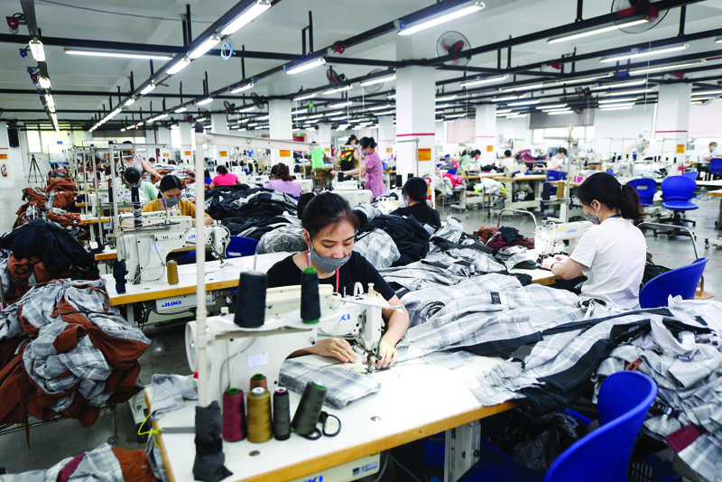 HANOI, Vietnam: This photograph taken on September 21, 2021 shows workers working at the Maxport factory, which makes activewear for various textile clothing brands, in Hanoi. - AFPnn