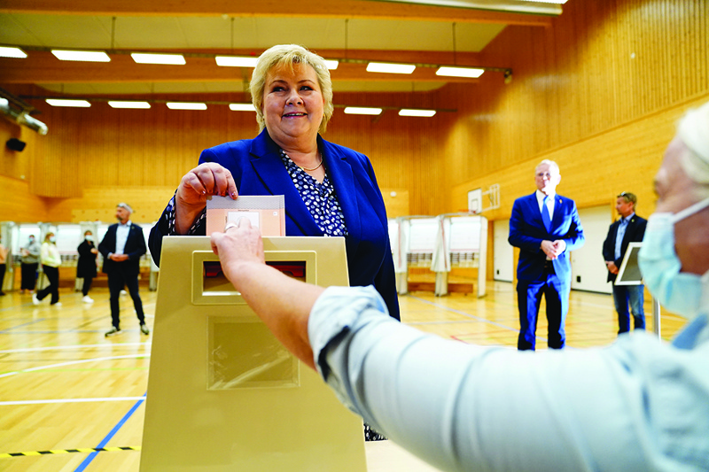 OSLO: Norwegian Prime Minister Erna Solberg, leader of the Conservative Party Hoyre, casts her vote for the 2021 parliamentary elections at Skjold School in her home town of Bergen yesterday.-AFPn