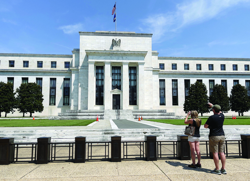WASHINGTON, US: People take pictures of the Federal Reserve building in Washington, DC. - AFPn