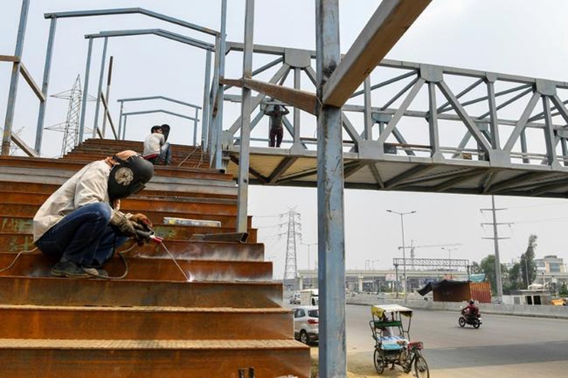Workers build a bridge in Ghaziabad, India. The Asian Development Bank has cut its growth forecast for developing Asia Prakash SINGH AFPn