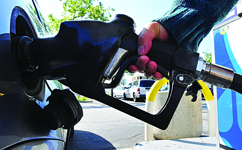 LOS ANGELES: In this file photo, a woman pumps gas into a vehicle in Los Angeles, California. US consumer price inflation slowed in August.-AFPn
