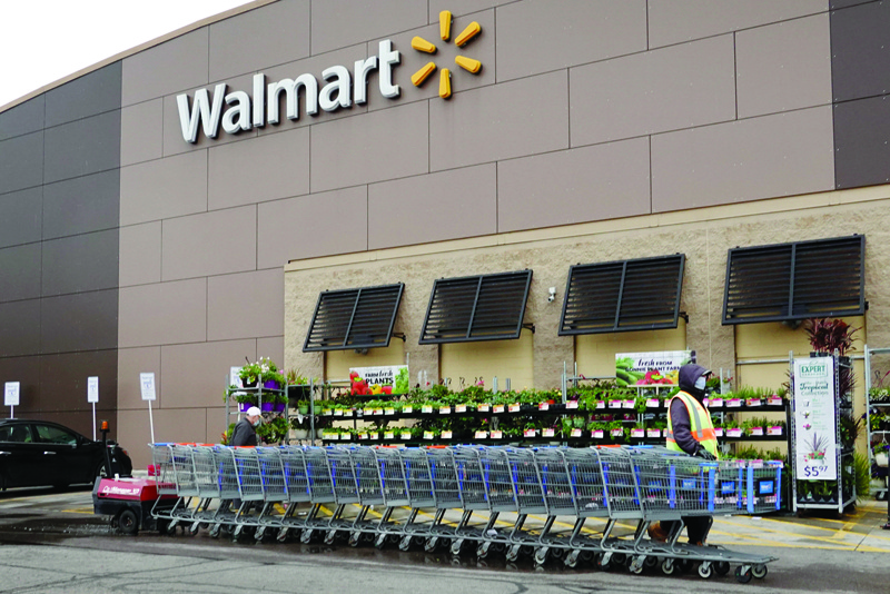 CHICAGO: In this file photo a worker collects shopping carts at a Walmart store in Chicago, Illinois. - AFPn