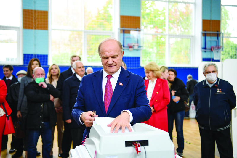 MOSCOW: Russian Communist party leader Gennady Zyuganov casts his ballot on the last day of the three-day parliamentary election in Moscow yesterday. - AFP n