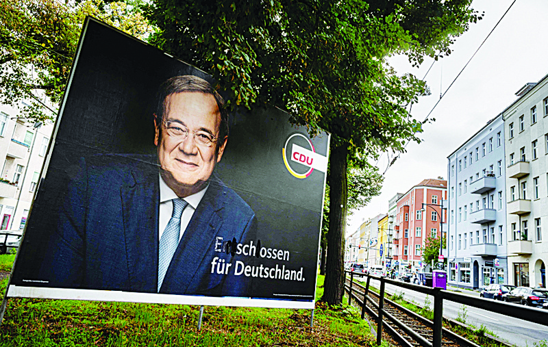 BERLIN: A defaced election campaign poster featuring Christian Democratic Union (CDU) party leader and candidate for Chancellor Armin Laschet reads: 'Shot dead for Germany' instead of 'Determined for Germany' in Berlin ahead of parliamentary elections on September 26. - AFP n