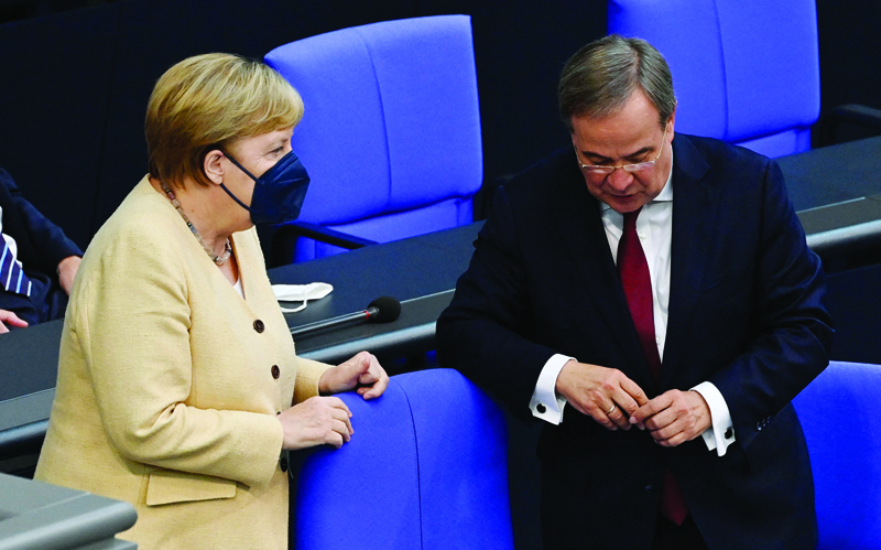 BERLIN: German Chancellor Angela Merkel talks with North Rhine-Westphalia's State Premier and Germany's conservative Christian Democratic Union's (CDU) chancellor candidate Armin Laschet during a session at the Bundestag, the German lower house of parliament yesterday. - AFP n