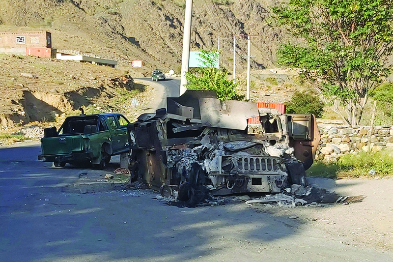 DASHTAK: A burned down Humvee vehicle is seen along a road in Dashtak area in Panjshir province, after the Taleban claimed total control over Afghanistan. - AFP n