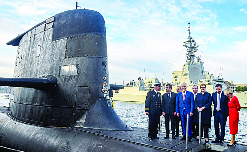 SYDNEY:  A file photo shows French President Emmanuel Macron (2nd left) and Australian Prime Minister Malcolm Turnbull (center) standing on the deck of HMAS Waller, a Collins-class submarine operated by the Royal Australian Navy, at Garden Island in Sydney. - AFP n