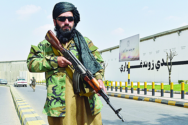 KABUL: A Taleban fighter stands guard along a street near the Zanbaq Square in Kabul yesterday. - AFP n