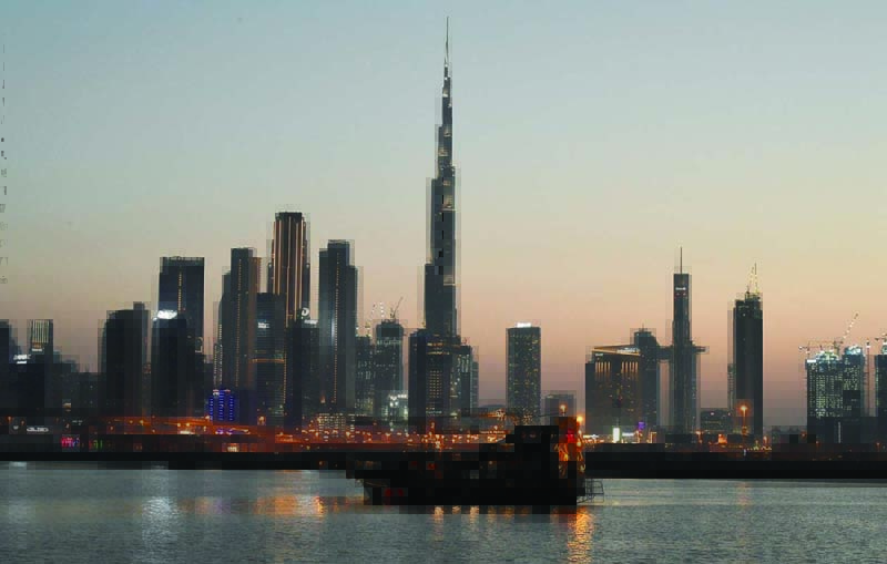 DUBAI: A boat sails at sunset against the backdrop of Burj Khalifa and high-rise buildings in this May 27, 2020 file photo. - AFP n