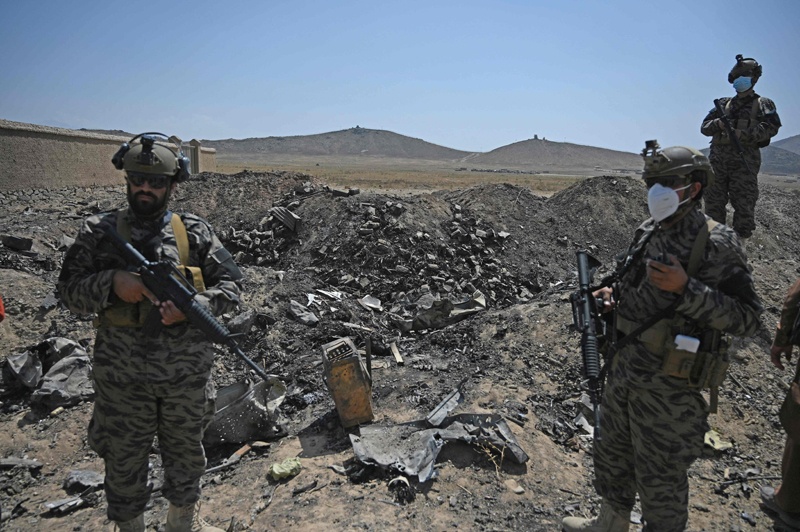 KABUL: Members of the Taleban Badri 313 military unit stand amid debris of the destroyed Central Intelligence Agency (CIA) base in Deh Sabz district northeast of the capital yesterday. – AFP n