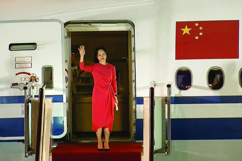 SHENZHEN: This screen grab made from video shows Huawei executive Meng Wanzhou waving as she steps out of the plane upon arrival yesterday following her release. - AFP n