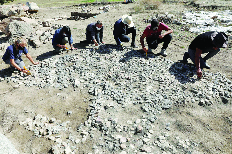 YOZGAT, Turkey: Archaeologists work at the site where a 3,500-year-old paving stone was discovered in Buyuk Taslik village in Sorgun district on Sept 21, 2021. - AFP n