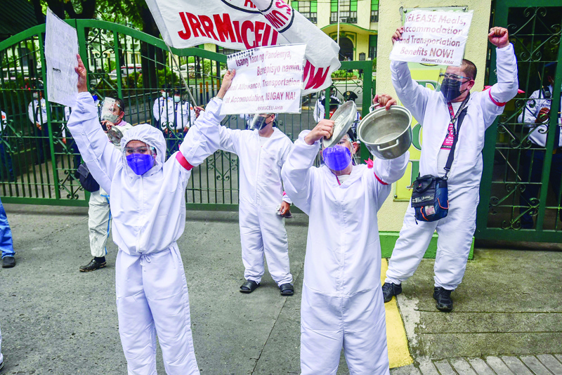 MANILA: This photo taken on Sept 1, 2021 shows health workers staging a protest to ask the government for hazard pay and benefits outside the department of health office. - AFP n