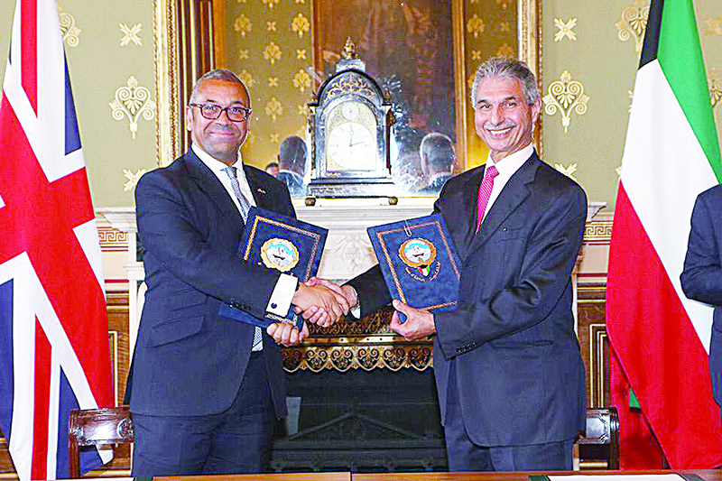 LONDON: British Minister of State for the Middle East and North Africa Affairs James Cleverly (left) and Kuwait's Deputy Foreign Minister Majdi Al-Dhafiri shake hands shake hands after signing the action plan.n