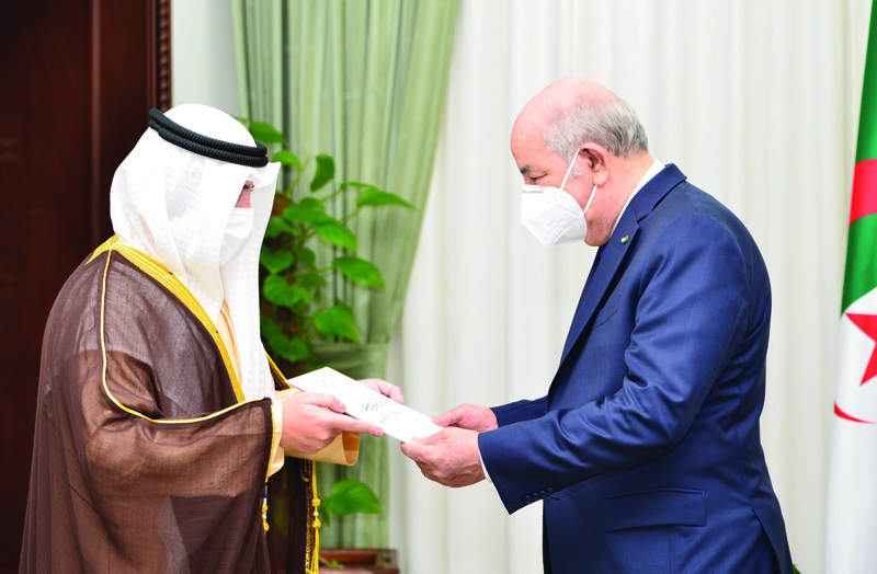 ALGIERS: Kuwaiti Foreign Minister Sheikh Dr Ahmad Nasser Al-Mohammad Al-Sabah hands a letter from His Highness the Amir Sheikh Nawaf Al-Ahmad Al-Jaber Al-Sabah to Algerian president Abdulmadjid Tebboune. - KUNAn