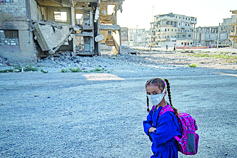 RAQA: A Syrian student walks to school past damaged buildings in the northern city of Raqqa, on September 23, 2021. - AFPn