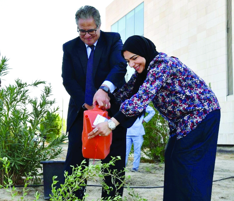 KUWAIT: UN Secretary-General's Resident Representative Dr Tarek Elsheikh (left) participates in a tree-planting campaign in Kuwait. - KUNAn