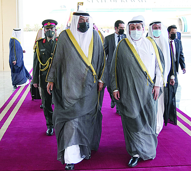 KUWAIT: His Highness the Prime Minister Sheikh Sabah Al-Khaled Al-Hamad Al-Sabah (left) is welcomed upon arrival in Kuwait yesterday. - KUNAn