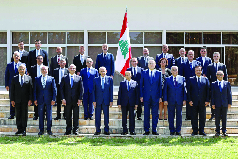 BAABDA, Lebanon:  Lebanon's Parliament Speaker Nabih Berri, President Michel Aoun and Prime Minister Najib Mikati pose for a group photo with the newly formed government at the presidential palace yesterday. - AFP n