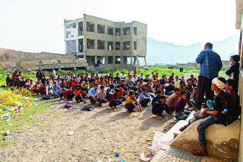 TAEZ: Yemeni students attend class in their destroyed school compound on the first day of the new academic year in the country's third-city of Taez. - AFPn