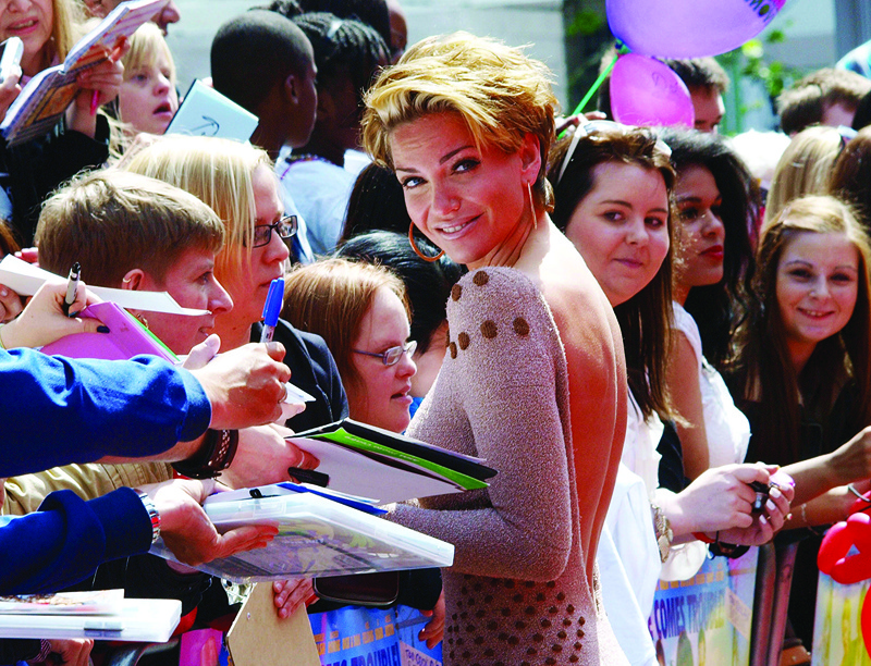 In this file photo Sarah Harding from the group 'Girls Aloud' meets with fans as she arrives at the premiere of the film,' Horrid Henry', in central London.—AFP n