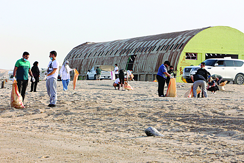 KUWAIT: People participate in a cleanup drive at the Ushairej beach yesterday to mark the International Coastal Cleanup Day. - Photos by Yasser Al-Zayyatn