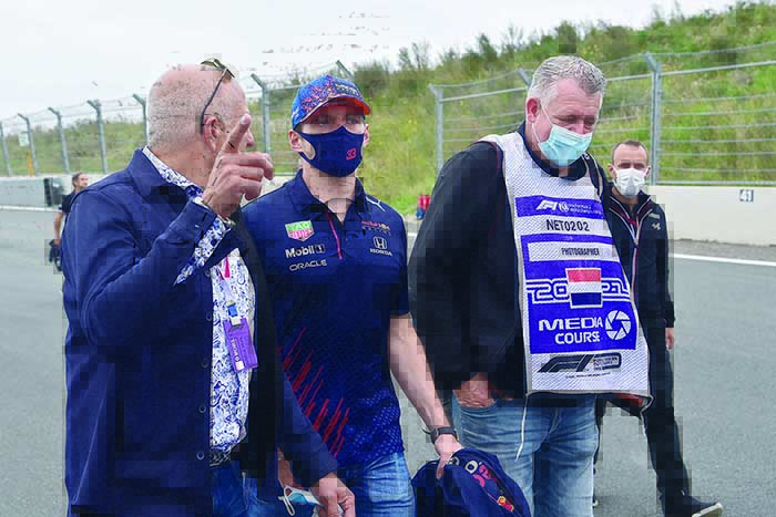 ZANDVOORT: Red Bull’s Dutch driver Max Verstappen (center) walks with team members and journalists on the track in Zandvoort yesterday, three days before the race of the 2021 Formula One Dutch Grand Prix. —AFP