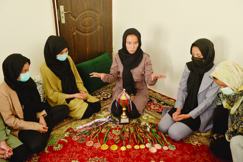 HERAT: This picture taken on Sept 21, 2021 shows taekwondo champion Zarghunna Noori (center) speaking with other members of the national taekwondo academy at a house in Herat province. - AFP n
