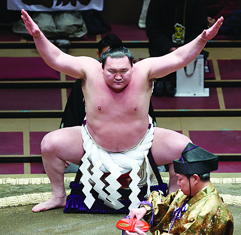 TOKYO: This picture taken on March 15, 2021 shows Mongolian-born sumo wrestler Hakuho performing a ring-entering ceremony at Ryogoku Kokugikan in Tokyo. - AFPnn