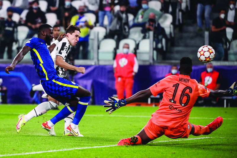 TURIN: Juventus' Italian forward Federico Chiesa (second left) shoots past Chelsea's Senegalese goalkeeper Edouard Mendy to open the scoring during the UEFA Champions League match at the Juventus stadium. - AFP  n