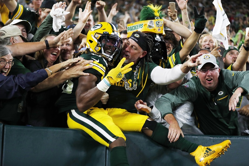GREEN BAY: Aaron Jones #33 of the Green Bay Packers does the Lambeau Leap to celebrate his third touchdown of the night against the Detroit Lions during the second half at Lambeau Field on Sunday. – AFPn