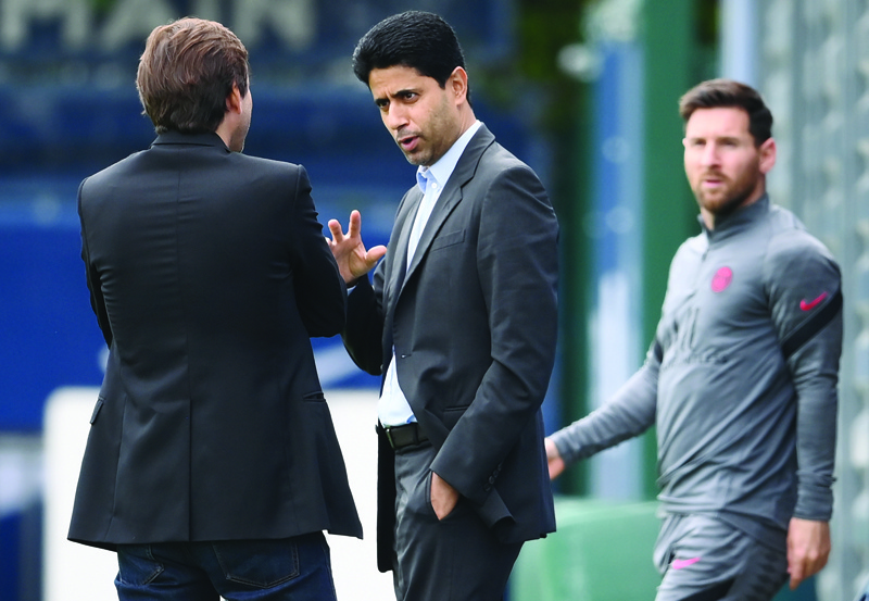 SAINT-GERMAIN-EN-LAYE, France: PSG's Brazilian sporting director Leonardo (left) speaks with president Nasser Al-Khelaifi as forward Lionel Messi arrives for a training session at the club's Camp des Loges training ground in Saint-Germain-en-Laye yesterday on the eve of their UEFA Champions League first round group A football match against Manchester City. - AFPn