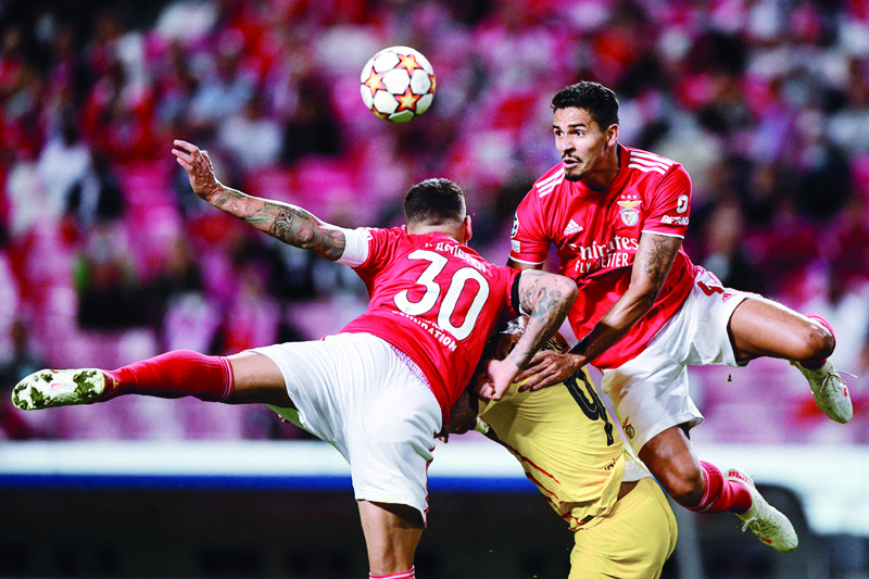LISBON: Benfica's Brazilian defender Lucas Verissimo (left) heads the ball in front of Barcelona's Dutch forward Memphis Depay and Benfica's Argentine defender Nicolas Otamendi during the UEFA Champions League match at the Luz stadium on Wednesday. - AFP n