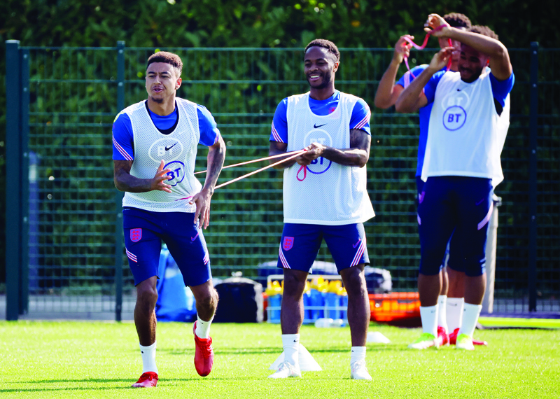 LONDON: England's midfielder Jesse Lingard (left) and England's midfielder Raheem Sterling attend an England training session at Hotspur Way, the Tottenham Hotspur training ground, in Enfield, north of London on Tuesday. - AFPn