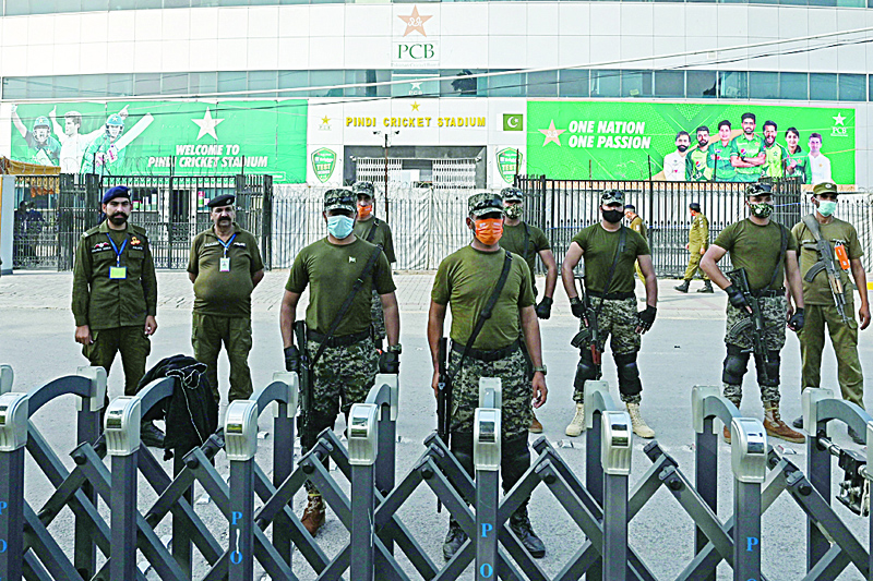 RAWALPINDI: Policemen stand guard outside the Rawalpindi Cricket Stadium in Rawalpindi on Friday, after New Zealand postponed a series of one-day international (ODI) cricket matches against Pakistan over security concerns. - AFPnn