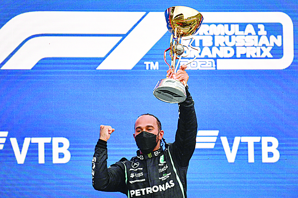 SOCHI: Winner Mercedes' British driver Lewis Hamilton celebrates on the podium after the Formula One Russian Grand Prix at the Sochi Autodrom circuit in Sochi yesterday. - AFPn