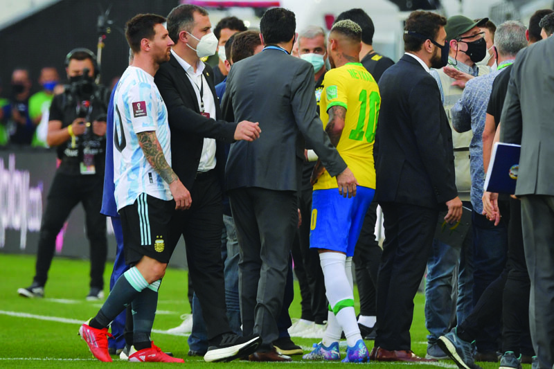 SAO PAULO: Argentina's Lionel Messi (left) and Brazil's Neymar are seen after employees of the National Health Surveillance Agency (Anvisa) entered to the field during the South American qualification football match for the FIFA World Cup Qatar 2022 between Brazil and Argentina at the Neo Quimica Arena in Sao Paulo, Brazil, on Sunday. - AFPn