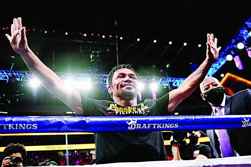 LAS VEGAS: This file photo taken on August 21, 2021 shows Manny Pacquiao of the Philippines waving and bowing at the crowd after losing against Yordenis Ugas of Cuba following the WBA Welterweight Championship boxing match at T-Mobile Arena in Las Vegas, Nevada. - AFPnn
