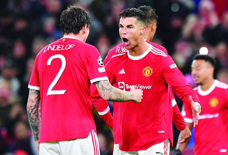 MANCHESTER: Manchester United's Portuguese striker Cristiano Ronaldo (center) celebrates with Manchester United's Swedish defender Victor Lindelof at the final whistle in the UEFA Champions League at Old Trafford stadium on Wednesday. - AFP n