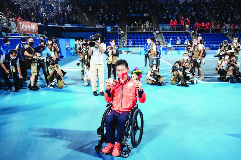 TOKYO: Japan's Shingo Kunieda poses in front of media after he won gold during his men's singles gold medal wheelchair tennis match against Netherlands' Tom Egberink at the Tokyo 2020 Paralympic Games at Ariake Tennis Park in Tokyo yesterday. - AFPn