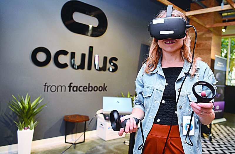 MENLO PARK, California: In this file photo, Facebook employee Elza Uzmanoff tries out an Oculus device at the company's corporate headquarters campus in Menlo Park, California. - AFPn
