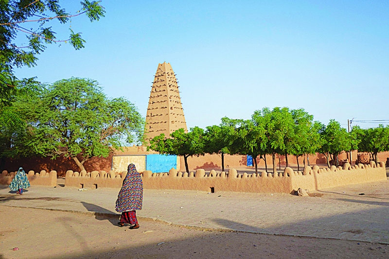 AGADEZ, Niger: A woman is seen walking in the old city of Agadez. Air Info and Sahara.fm represents today the main source of information on the Nigerien Sahara. - AFP n