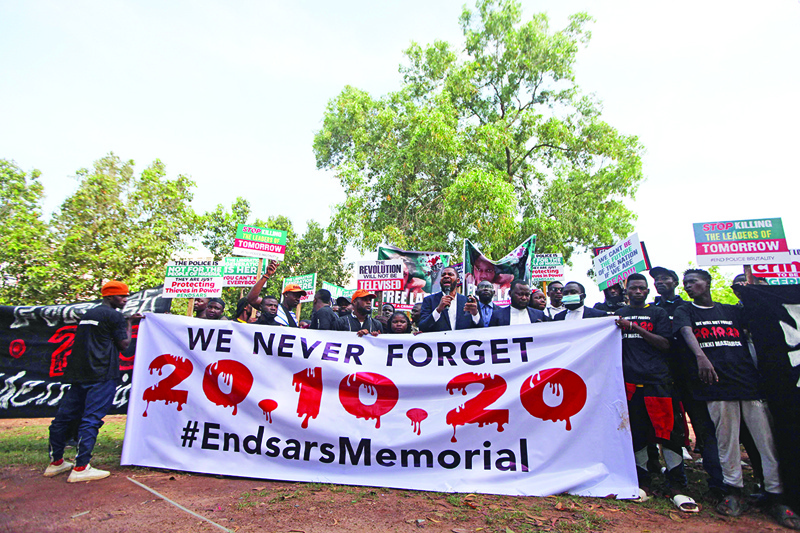 ABUJA: Protesters gather with placards in their hand, during a protest to commemorate one year anniversary of EndSars, a protest movement against police brutality at the Unity Fountain in Abuja yesterday. – AFP n