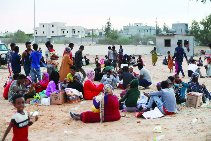TRIPOLI: African migrants gather at a makeshift shelter in the capital Tripoli's suburb of Ain Zara. -  AFP n
