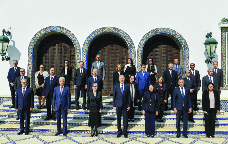 TUNIS: A handout photo shows President Kais Saied (center) and Prime Minister Najla Bouden (3rd left) posing with the ministers of the new government in Tunis yesterday. - AFP n