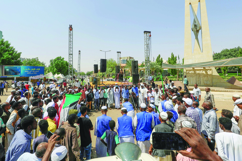 KHARTOUM: Sudanese protesters take part in the second day of a sit-in demanding the dissolution of the transitional government, in the capital Khartoum yesterday. - AFP n