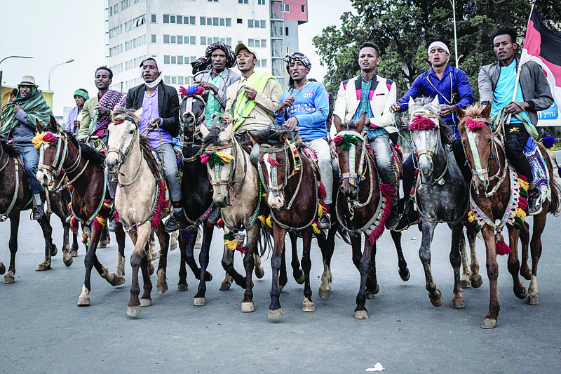 ADDIS ABABA: Horse riders are on a street as Ethiopian Prime Minister Abiy Ahmed is sworn in for a new five-year term in Addis Ababa, Ethiopia yesterday. - AFP  n
